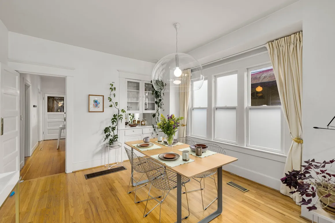 White dining room with wooden table