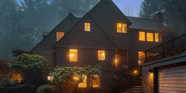 Cabin at dusk with warm interior lights