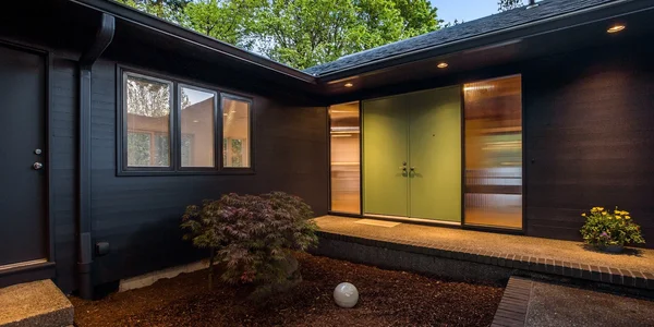Black exterior with green front door