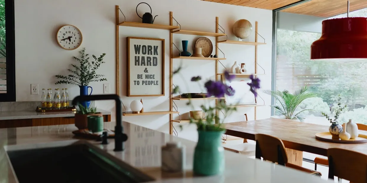 Bright kitchen with WORK HARD & BE NICE TO PEOPLE poster